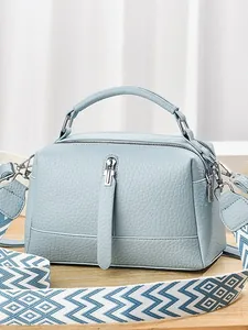 Minimalist light blue leather pillow bag with stylish wide woven strap for women