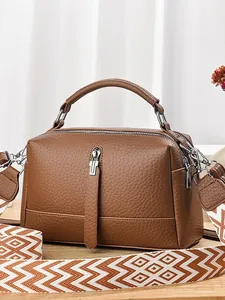 Brown lychee leather boston bag with geometric woven shoulder strap for women
