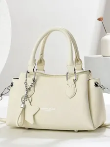 Minimalist cream white leather tote bag with lychee texture and star charm accessory