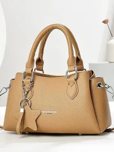 Minimalist tan pebbled leather tote bag with star charm for daily women's commute