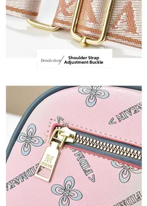 Detail of pink leather bag with clover pattern and gold adjustable strap buckle