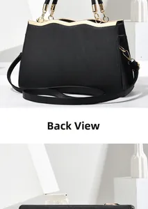 Detail shot of the back view of a black crossgrain leather tote with gold metal accents