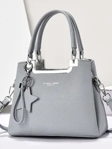 Sac à main élégant en cuir bleu clair grainé avec poignées argentées et breloque étoile