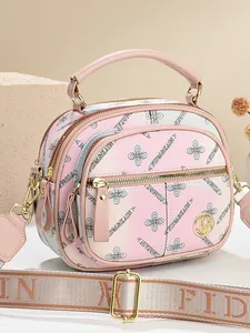 Pink gradient floral tote bag with wide logo strap and gold hardware front view