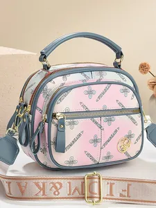 Floral printed multi-pocket handbag with wide jacquard shoulder strap in pink gradient
