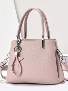 Elegant dusty pink pebbled leather handbag with spacious design for women on white background