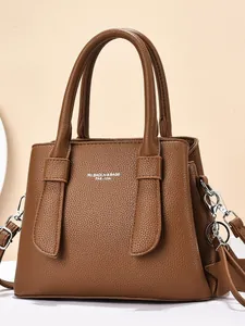 Brown lychee grain leather handbag with top handles and silver metal buckles