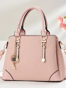 Elegant light pink trapezoid tote bag with textured faux leather and gold hardware