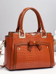Brown crocodile embossed leather handbag with elegant bow decoration and dual handles