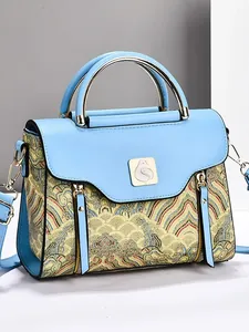 Blue leather shoulder bag with traditional gold embroidery and metal handle detail