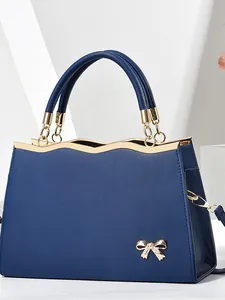 Fashionable dark blue Saffiano leather handbag with gold wave trim and butterfly detail