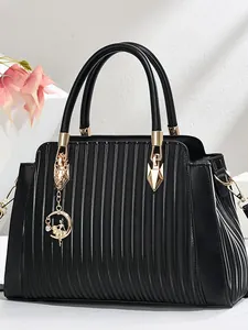 Elegant black pleated leather tote bag for women with gold hardware and ballet girl charm