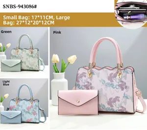 Detailed view of floral print tote set with metal ring handle and envelope clutch