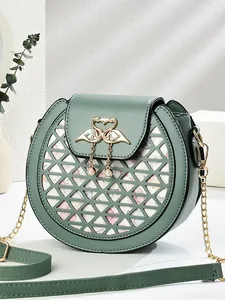 Dark green round crossbody bag with geometric cutouts and swan pearl metal ornament