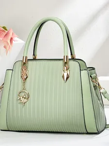 Sage green large capacity tote bag with vertical embossing and golden ballerina pendant