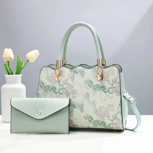 Elegant mint green two-piece handbag set with floral embroidery and gold hardware