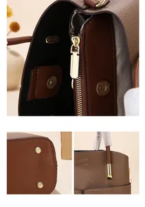 Close-up of brown leather bucket bag showing gold hardware and herringbone lining