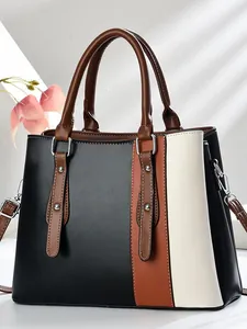 Chic color-block tote bag in black, brown and beige with silver hardware and shoulder strap