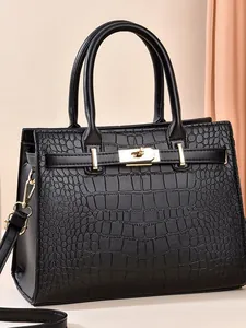 Elegant black crocodile embossed handbag with gold metal lock and adjustable strap