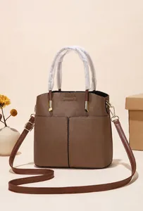 Detailed macro view of brown lychee grain leather texture and premium gold hardware