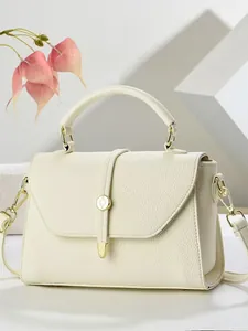 Beige lychee pattern leather handbag with gold metal hardware and detachable strap
