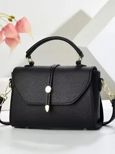 Chic black litchi pattern square handbag with gold drop lock and detachable strap