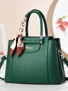Dark green pebbled leather tote bag for women with decorative silk scarf and silver hardware