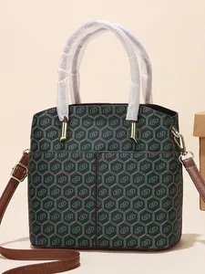 Stylish bucket bag with geometric blue textures and brown leather shoulder strap
