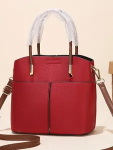 Red textured bucket bag with front pockets and brown top handles for women