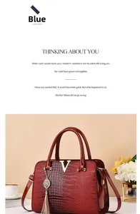 Macro shot of burgundy faux crocodile leather tote featuring golden V-hardware and tassel