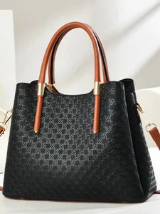 Classic black woven texture tote bag with brown leather handles and gold metal accents