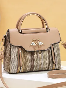 Striped crossbody bag with beige texture and elegant golden flamingo clasp detail