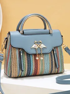 Colorful striped crossbody bag with blue leather flap and elegant swan metal clasp
