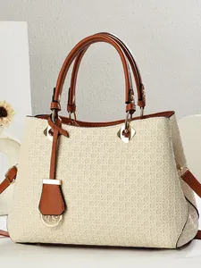 Woven texture tote bag in beige and brown with durable leather handles and metal hardware