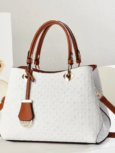 White woven texture shoulder bag with brown handles and a gold hardware finish