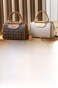 Detailed view of Boston bags featuring textured monogram prints and polished metal hardware