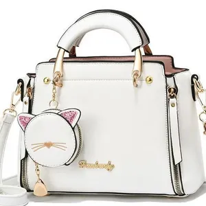 White structured Danbaoly handbag with cute cat pouch and golden hardware on white background