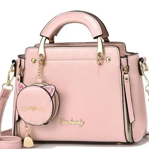 Pink faux leather tote bag with round handles and a cute cat-shaped coin purse charm