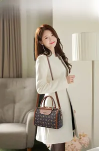 Fashionable Boston handbag with printed patterns and leather handles in a home setting
