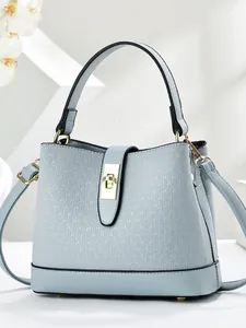 Minimalist light blue bucket bag with woven texture and gold metallic twist lock