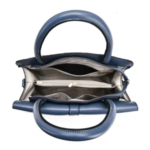 Top view of blue leather handbag showing interior compartments and zipper pockets