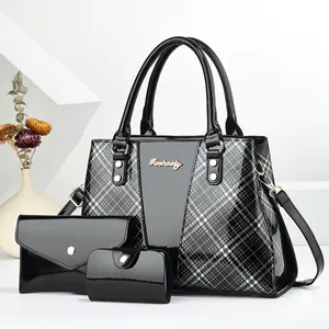 Detailed set of black patent leather tote, clutch, and card holder with plaid stitching