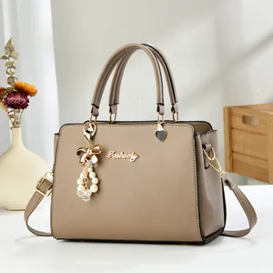 Detailed view of beige faux leather handbag with Danbaoly logo and elegant pendant