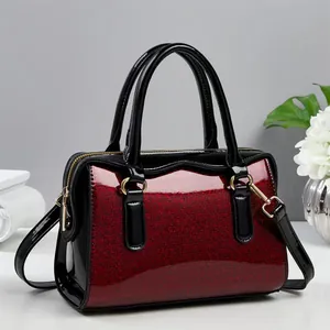 Elegant red glitter and black patent leather tote bag with gold metal buckles for women
