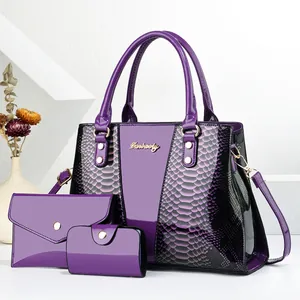 Detailed close-up of purple snake pattern textures and golden logo on fashion bag set