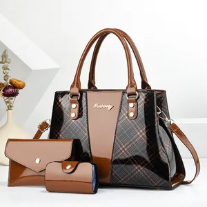 Detailed view of 3-piece bag set with glossy coffee faux leather and gold hardware