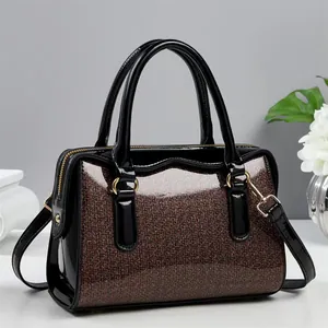 Elegant red-brown Boston bag with glitter finish and black patent leather straps