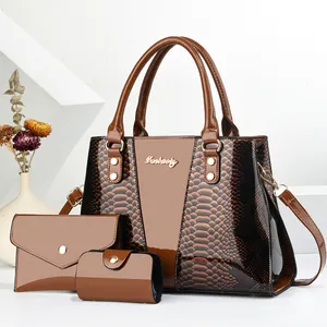Three-piece brown glossy snakeskin textured handbag set including wallet and pouch