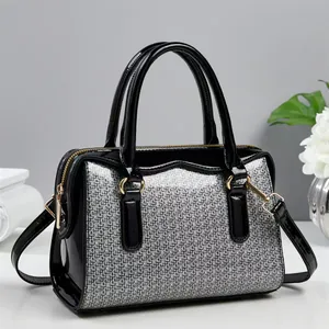 Elegant black patent leather Boston bag with silver sequins and gold hardware detail