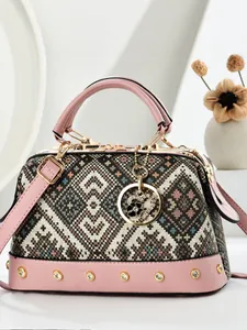 Retro geometric jacquard pillow bag with pink leather trim and heart charm detail